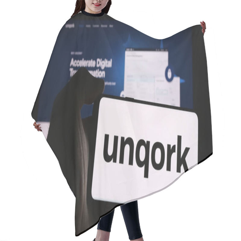 Personality  Stuttgart, Germany - 08-25-2024: Person Holding Mobile Phone With Logo Of US Enterprise Application Platform Company Unqork Inc. In Front Of Web Page. Focus On Phone Display. Hair Cutting Cape