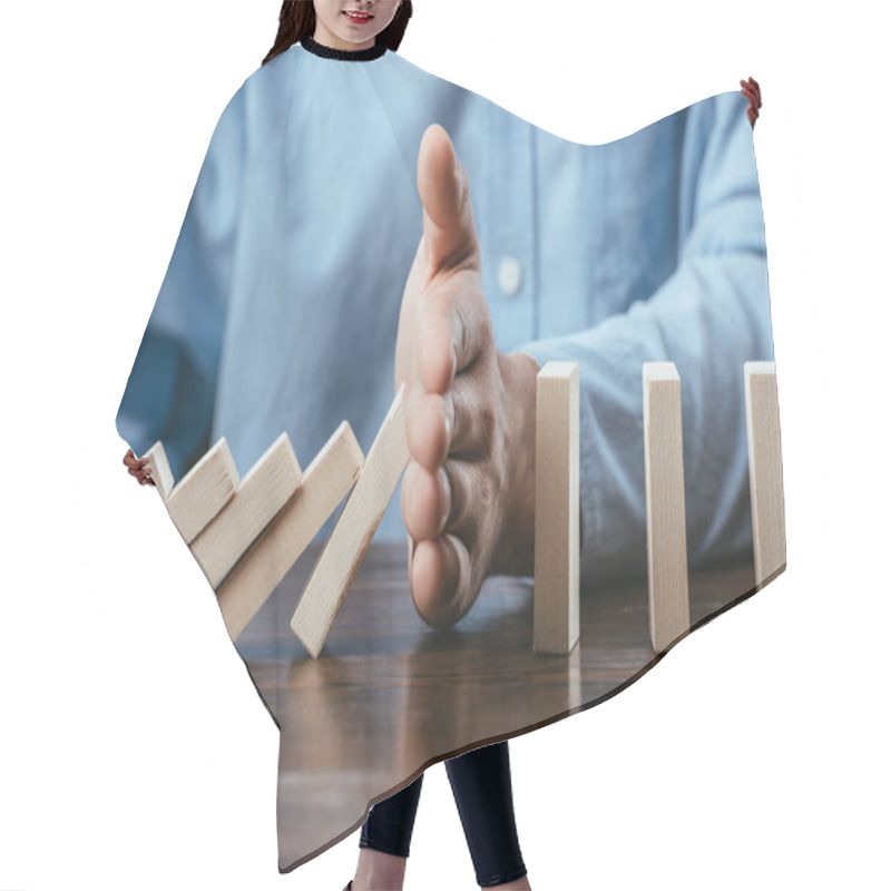 Personality  Close Up View Of Man Sitting At Desk And Preventing Wooden Blocks From Falling  Hair Cutting Cape