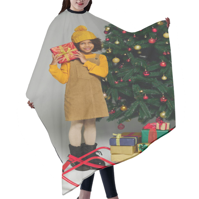 Personality  A Cheerful Young Girl Stands Smiling With A Present, Surrounded By Christmas Decorations. Hair Cutting Cape