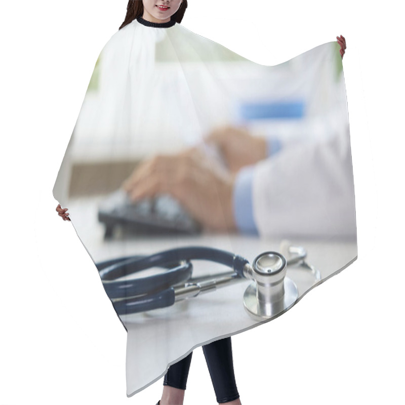 Personality  Stethoscope On The Table In Clinic Office. Doctor Working On Computer In Background Hair Cutting Cape