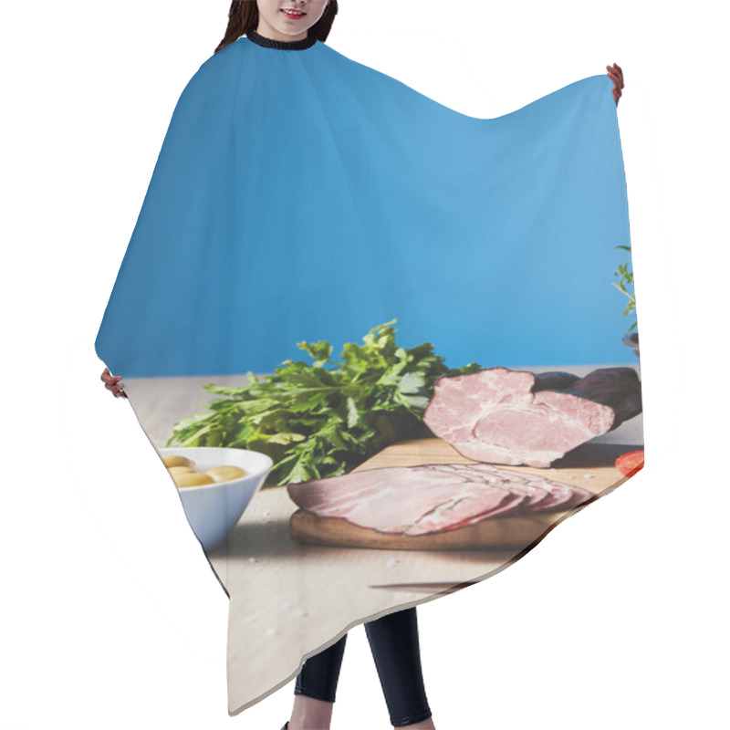 Personality  Selective Focus Of Tasty Ham On Cutting Board With Knife, Parsley, Olives On Wooden Table On Blue Background Hair Cutting Cape