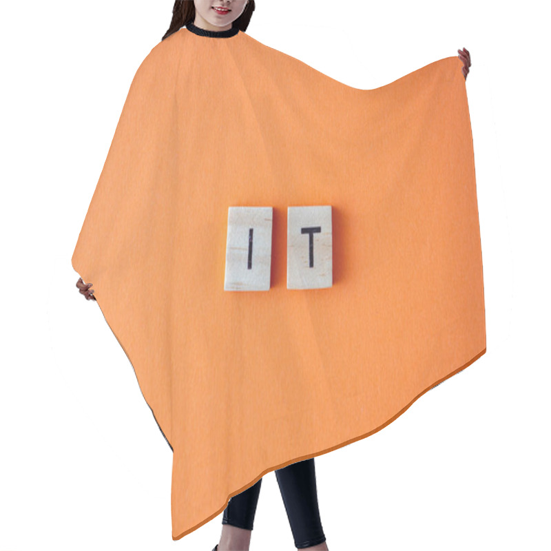 Personality  IT Word. The Phrase Is Laid Out In Wooden Letters Top View. Orange Flat Lay Background Hair Cutting Cape