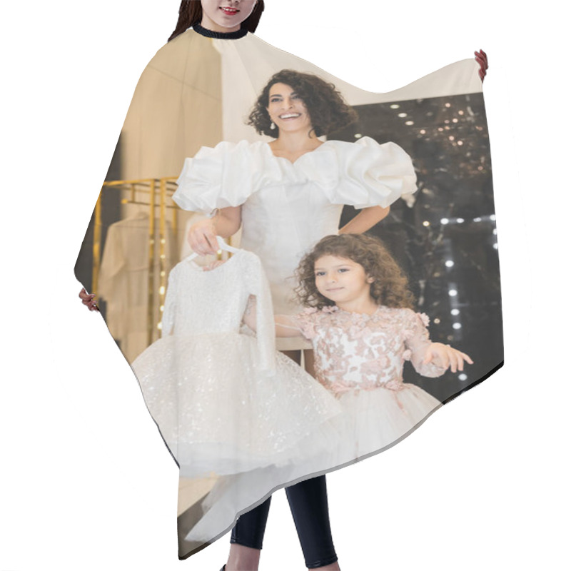 Personality  Charming Middle Eastern Bride With Brunette Hair Standing In White Wedding Gown With Puff Sleeves And Ruffles And Holding Girly Dress With Tulle Skirt Near Daughter In Bridal Store  Hair Cutting Cape