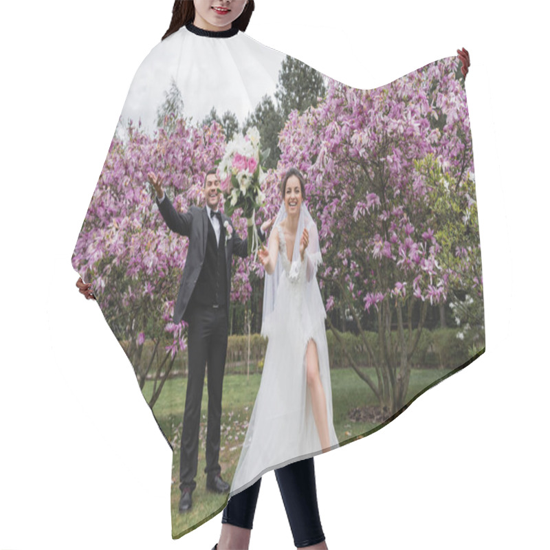 Personality  Happy Newlyweds Standing Near Falling Bouquet In Park  Hair Cutting Cape