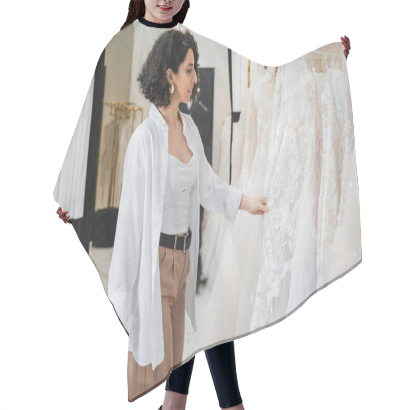 Personality  Side View Of Happy Middle Eastern Woman With Brunette And Wavy Hair Standing In Beige Pants With White Shirt And Holding Shopping Bags While Choosing Wedding Dress In Bridal Boutique  Hair Cutting Cape