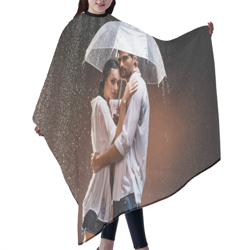 Personality  Young Couple In Wet Shirts Standing Under Rain With Transparent Umbrella On Dark Background Hair Cutting Cape