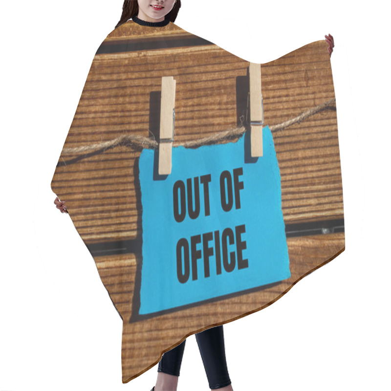 Personality  Out Of Office Message Written On Ripped Blue Torn Paper Piece With Wooden Background. Conceptual Out Of Office Symbol. Copy Space. Hair Cutting Cape