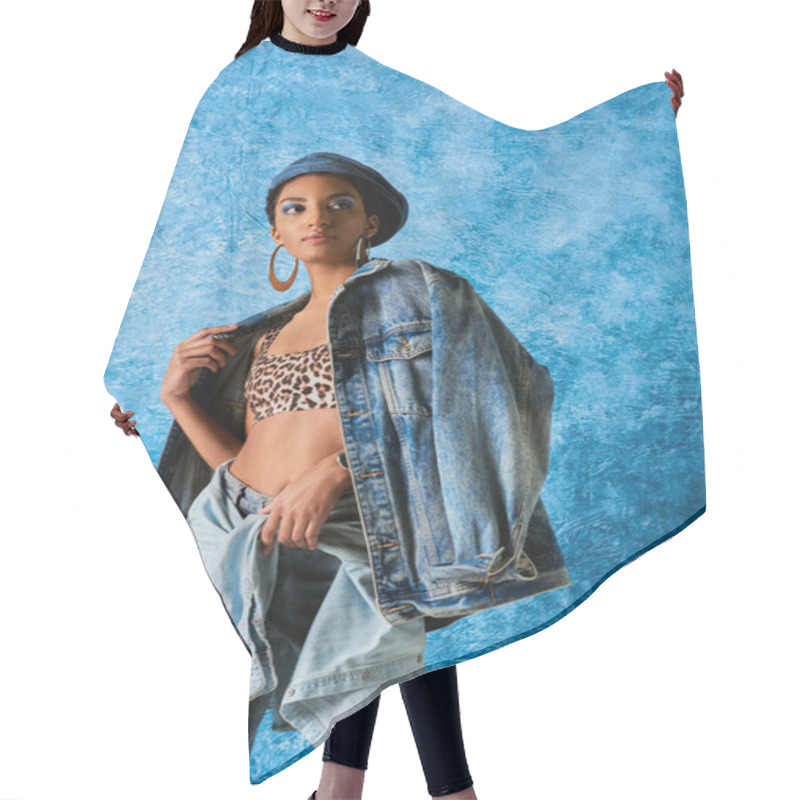 Personality  Modern African American Woman With Bold Makeup And Beret Wearing Denim Jacket, Top With Animal Print And Jeans While Standing On Blue Textured Background, Stylish Jeans Look Hair Cutting Cape