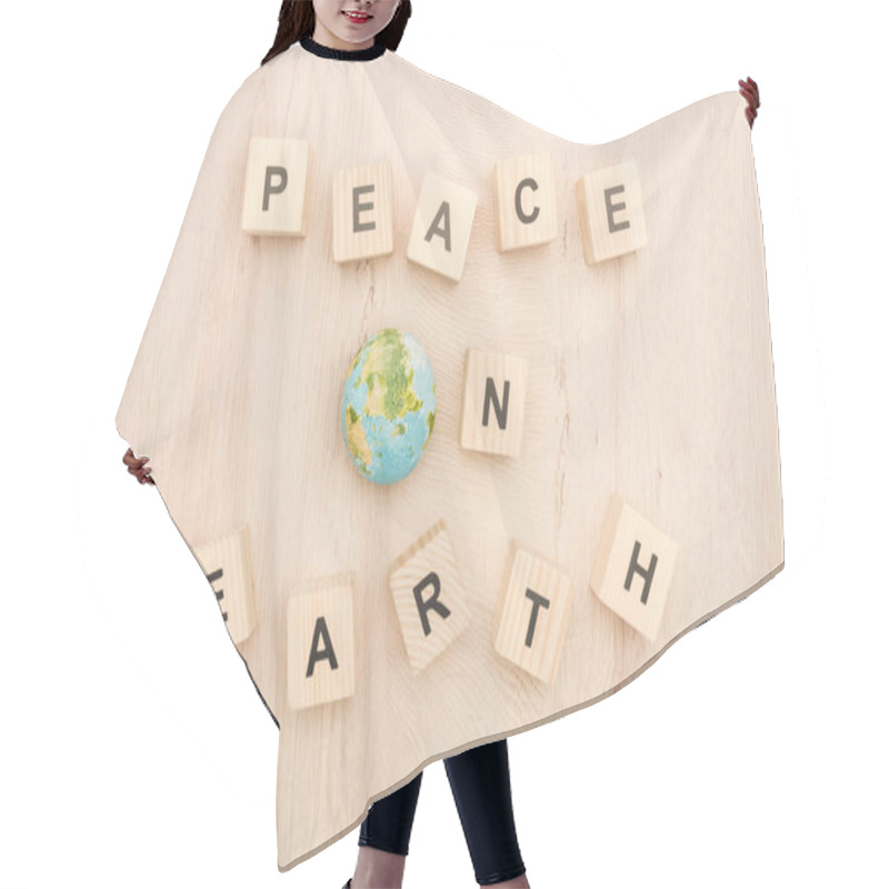 Personality  Top View Of Cubes With Peace On Earth Lettering And Toy Planet On Wooden Background  Hair Cutting Cape