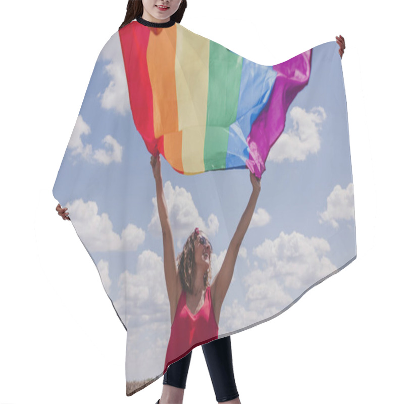 Personality  Woman Holding The Gay Rainbow Flag Over Blue And Cloudy Sky Outdoors. Happiness, Freedom And Love Concept For Same Sex Couples. LIfestyle Outdoors Hair Cutting Cape