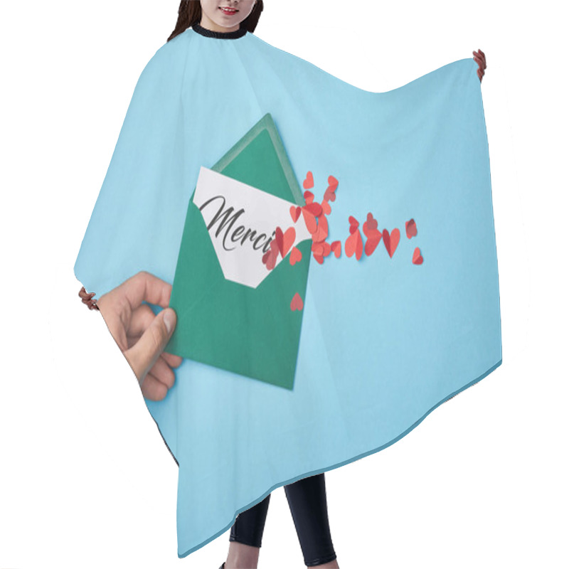 Personality  Cropped View Of Man Holding Green Envelope With Merci Lettering On White Card And Paper Cut Red Hearts On Blue Background Hair Cutting Cape