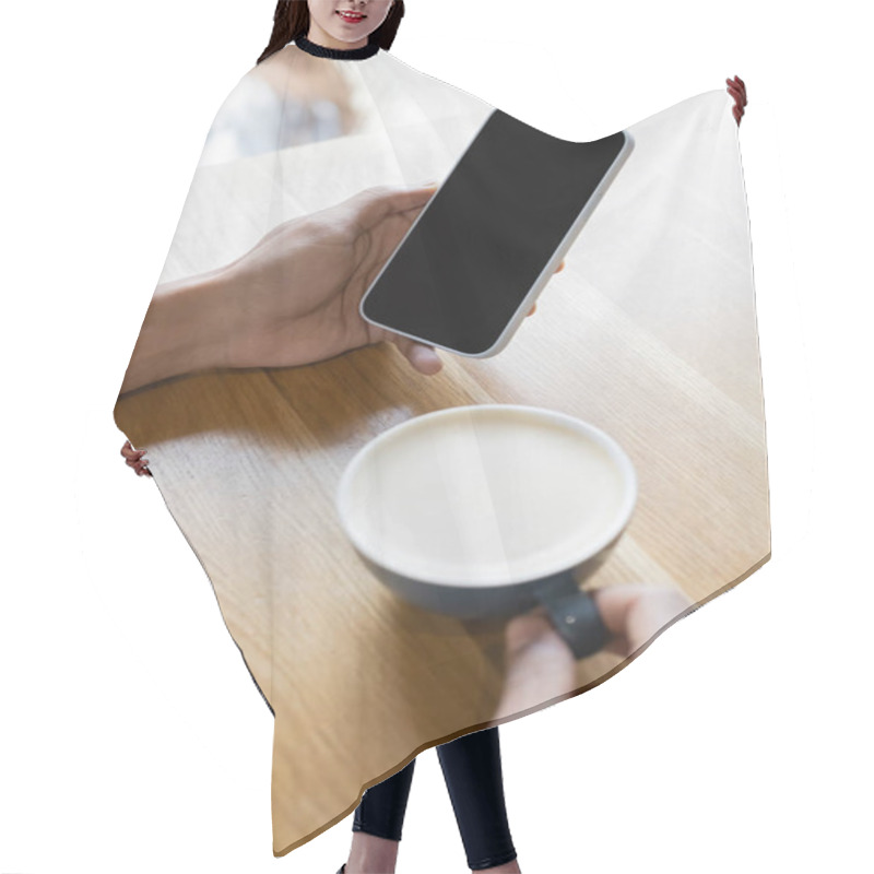 Personality  Cropped View Of Blurred African American Man Holding Smartphone With Blank Screen Near Cup Of Cappuccino  Hair Cutting Cape