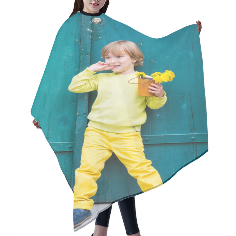 Personality  Outdoor Portrait Of A Cute Little Boy, Wearing Yellow Pullover And Trousers, Standing By The Green Wooden Door, Holding Bucket With Flowers Dandelions Hair Cutting Cape