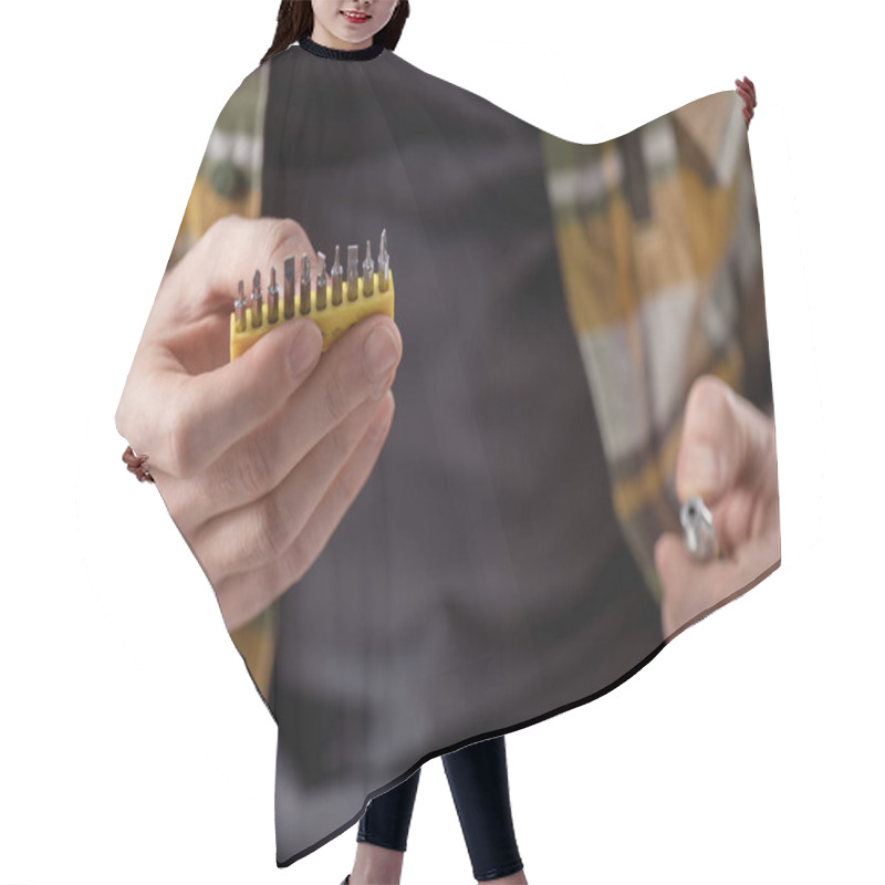 Personality  Cropped Image Of Hands Holding Screwdriver And Its Attachments  Hair Cutting Cape