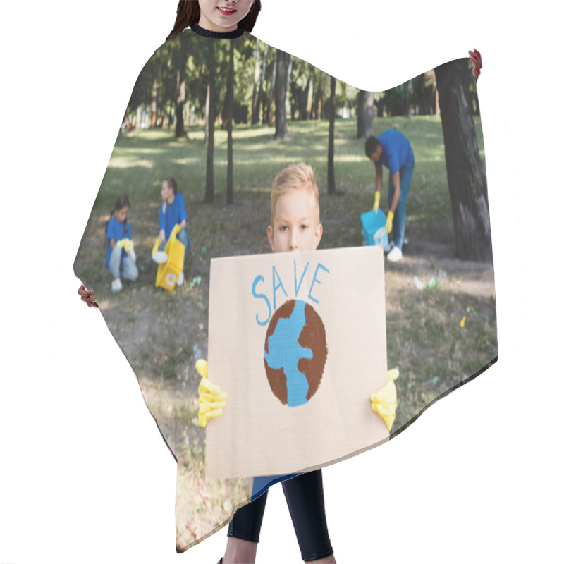 Personality  Boy Holding Placard With Globe And Save Inscription, While Family Collecting Plastic Waste On Blurred Background, Ecology Concept Hair Cutting Cape