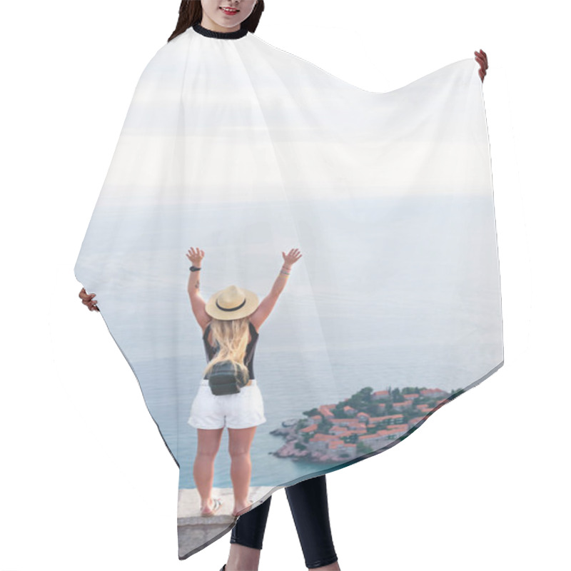 Personality  Back View Of Woman Standing With Raised Hands And Looking At Saint Stephen Island In Adriatic Sea, Budva, Montenegro Hair Cutting Cape