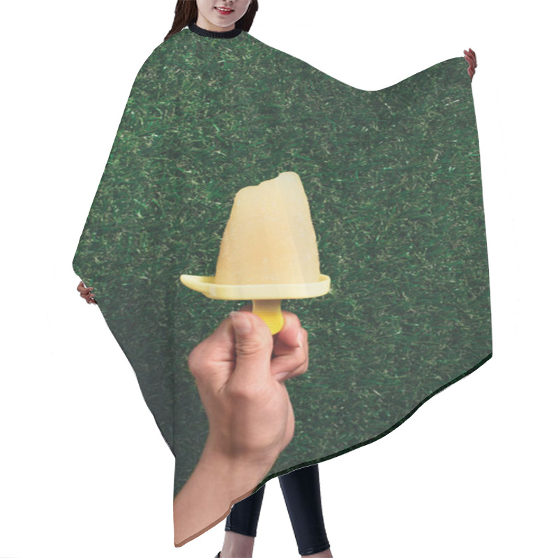 Personality  Hand Holding Delicious Popsicle On Green Grass Background Hair Cutting Cape