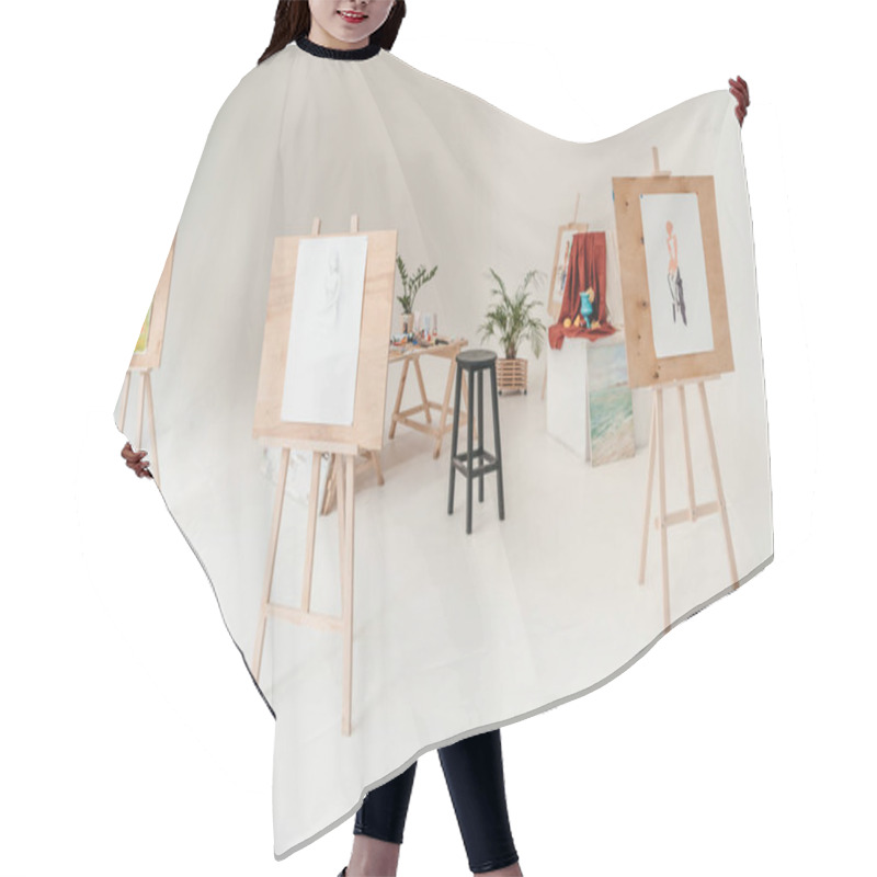 Personality  Easels With Paintings In Empty Art Studio Hair Cutting Cape