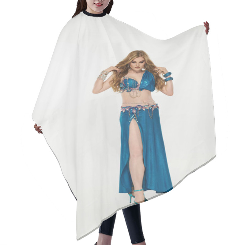 Personality  A Graceful Young Woman In A Vibrant Blue Belly Dance Costume Sways Elegantly. Hair Cutting Cape