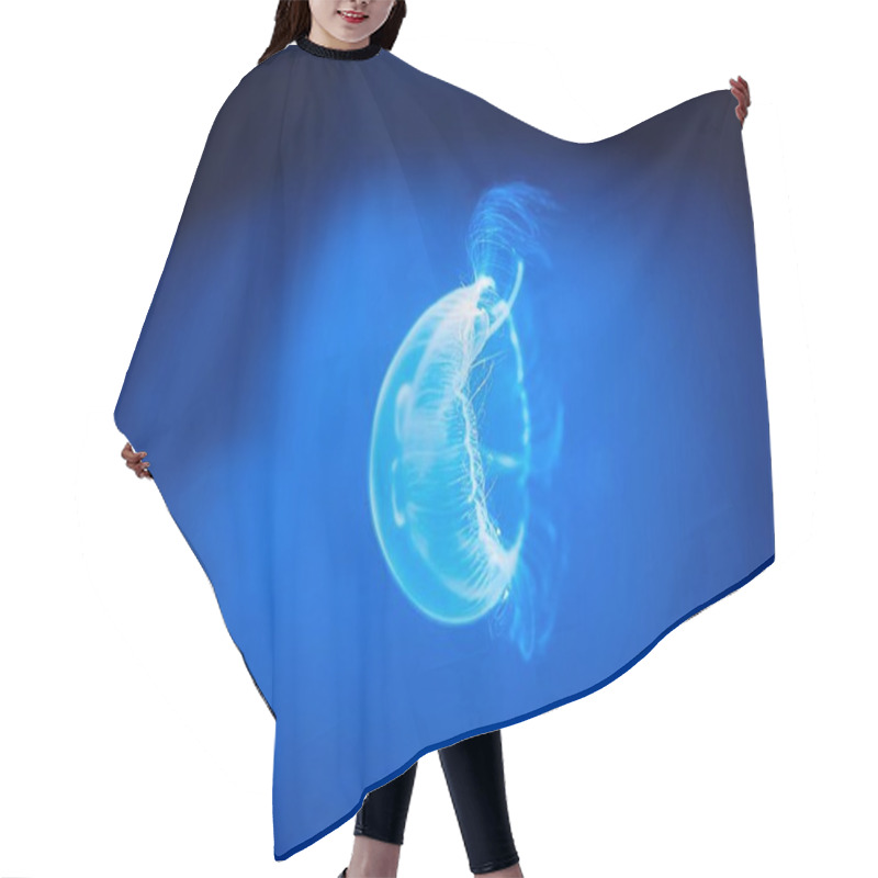 Personality  A Glowing Jellyfish Floats Gracefully Through The Deep Blue Ocean, Its Bioluminescent Body Pulsating Softly. This Captivating Scene Showcases The Mysterious Beauty Of Marine Life In The Depths. Hair Cutting Cape