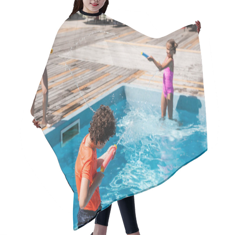 Personality  Selective Focus Of Boy And Two Girls Fighting With Water Guns Near Pool Hair Cutting Cape