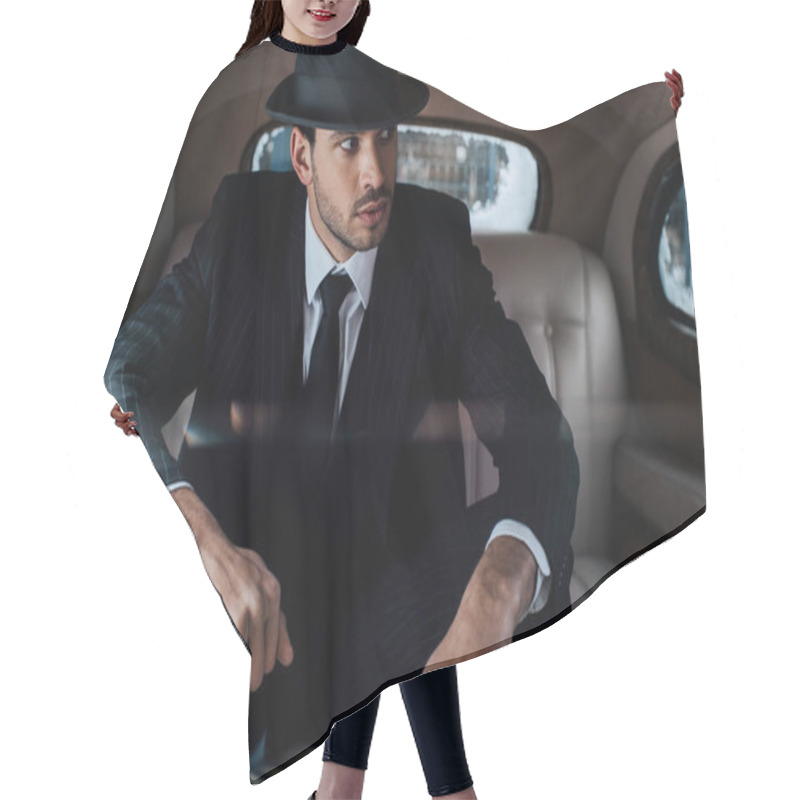 Personality  Selective Focus Of Tense Mafioso In Black Suit And Felt Hat In Retro Car Hair Cutting Cape