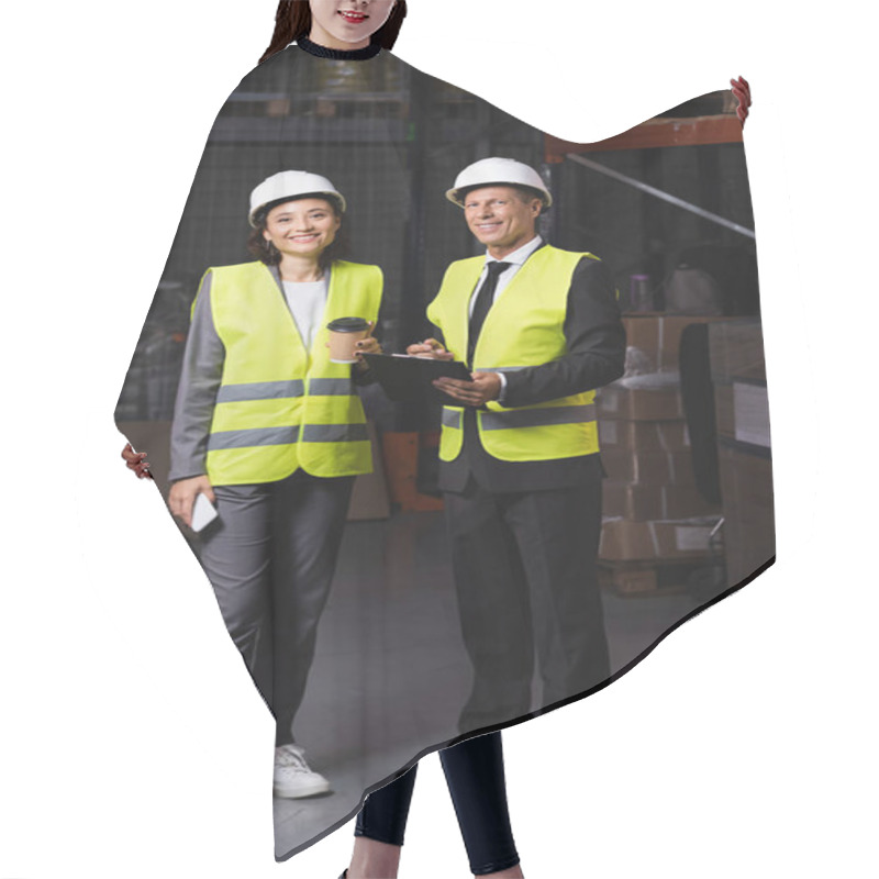 Personality  Warehouse Supervisor With Clipboard And Female Employee With Coffee And Smartphone Looking At Camera Hair Cutting Cape