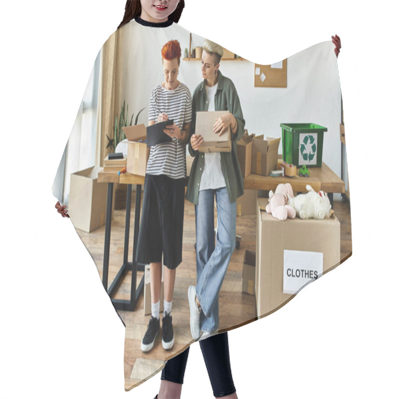 Personality  Couple Stand In A Room Filled With Boxes, Working Together On A Charity Project. Hair Cutting Cape