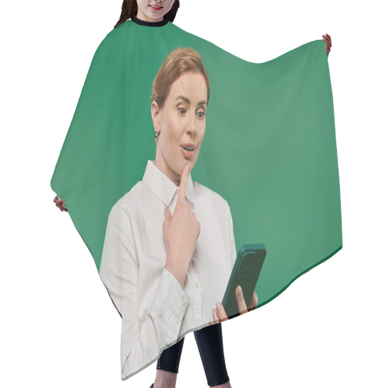 Personality  A Confident Woman Dressed In Formal Wear Thoughtfully Engages With Her Smartphone, Set Against A Vivid Green Backdrop. Hair Cutting Cape