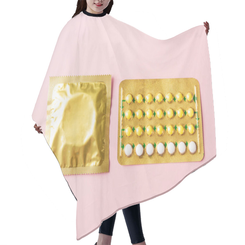 Personality  World Sexual Health Or Aids Day, Condom In Wrapper Pack And Contraceptive Pills Blister Hormonal Birth Control Pills, Studio Shot Isolated On A Pink Background, Safe Sex And Reproductive Health Concept Hair Cutting Cape