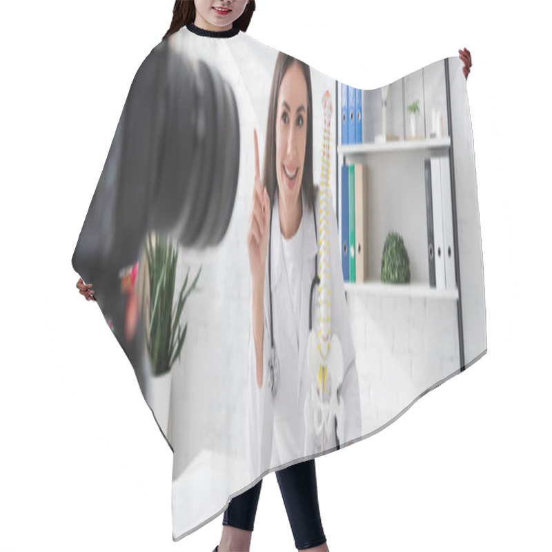 Personality  Smiling Doctor Gesturing Near Spinal Model And Blurred Digital Camera In Clinic, Banner  Hair Cutting Cape