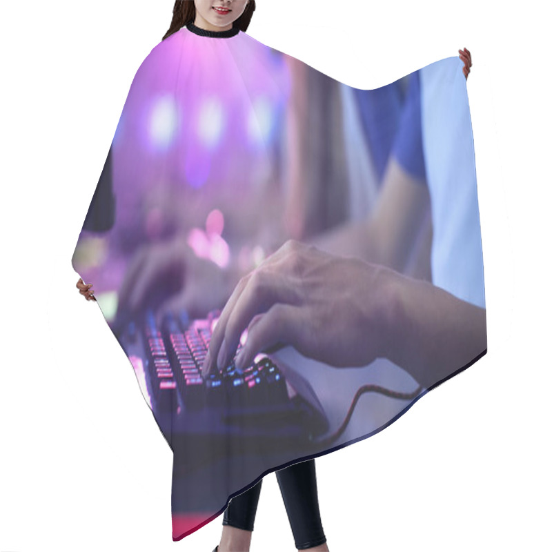 Personality  Close-up On Gamer's Hands On A Keyboard, Actively Pushing Buttons, Playing MMO Games Online. Background Is Lit With Neon Lights. Hair Cutting Cape