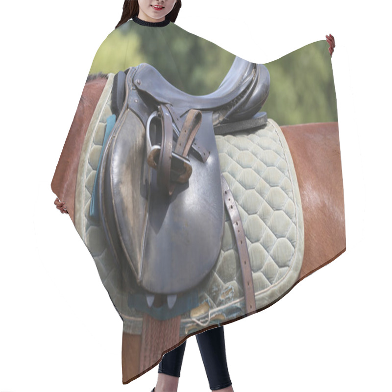 Personality  On The Back Of The Horse, A Brown Leather Saddle And Saddle Cloth Are Worn On Top. Illuminated By Sunlight Ready For Equestrian Training Outdoor Hair Cutting Cape