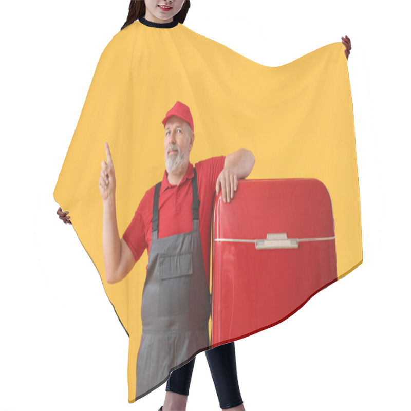 Personality  Mature Worker With Retro Fridge Pointing At Something On Yellow Background Hair Cutting Cape