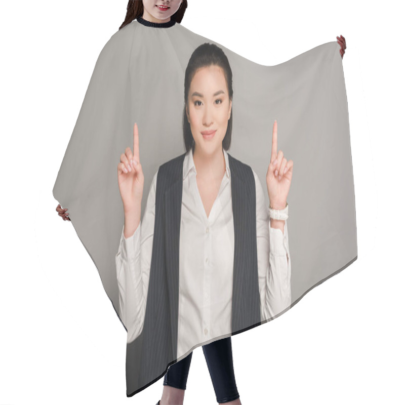 Personality  Smiling Young Businesswoman Pointing With Fingers Up On Grey Background Hair Cutting Cape