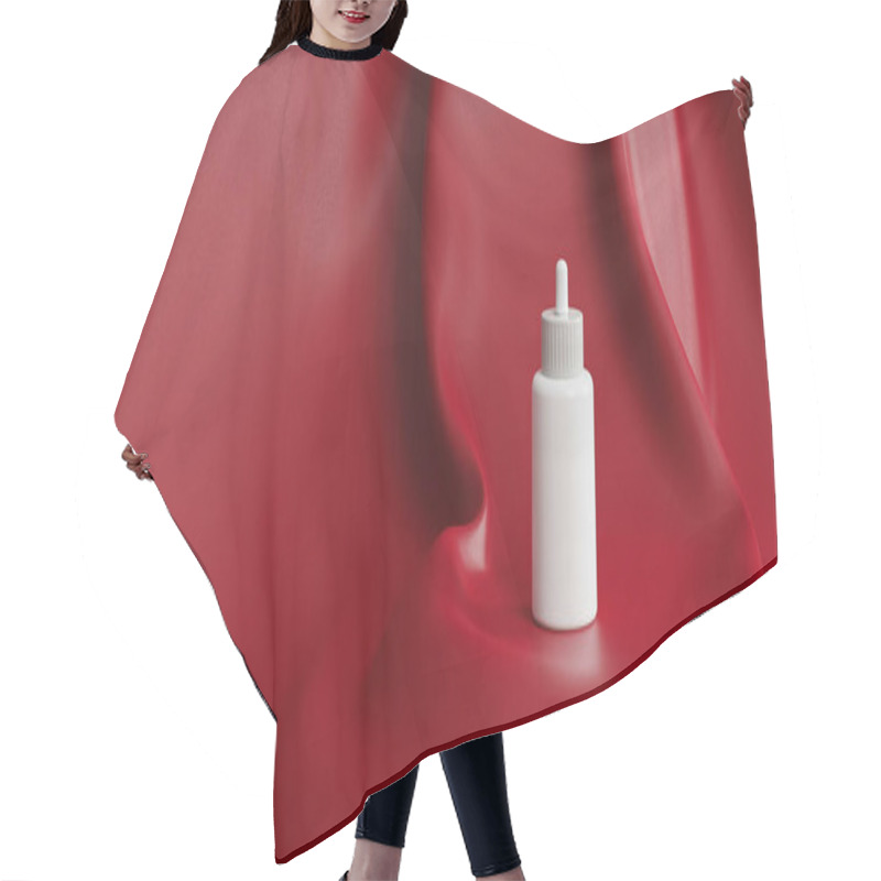 Personality  A Minimalist White Bottle Set Against A Vibrant Red Backdrop. Hair Cutting Cape