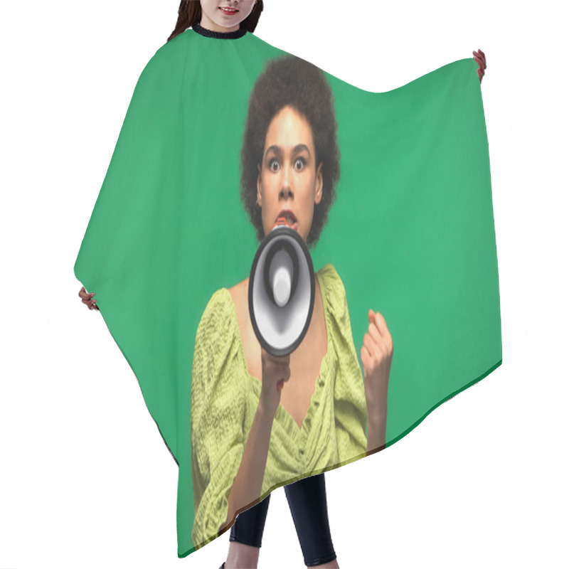 Personality  Irritated African American Woman Protesting While Holding Loudspeaker And Looking At Camera Isolated On Green  Hair Cutting Cape