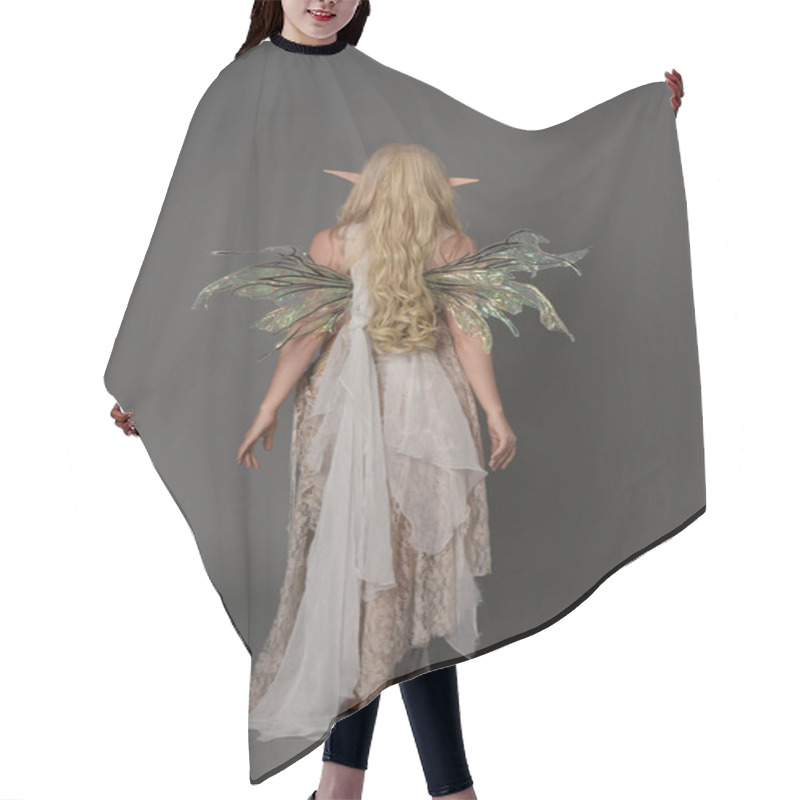 Personality  Full Length Portrait Of Blonder Wearing Fairy Costume, Standing Pose With Back To The Camera.  Grey Studio Background. Hair Cutting Cape