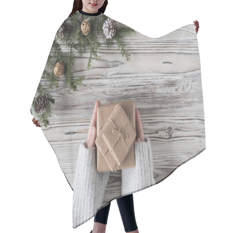 Personality  Female Packing Gifts. Cardboard Box In Craft Paper, Christmas Rope And Tree On The Rustic Wood Planks Background. DIY. Hair Cutting Cape