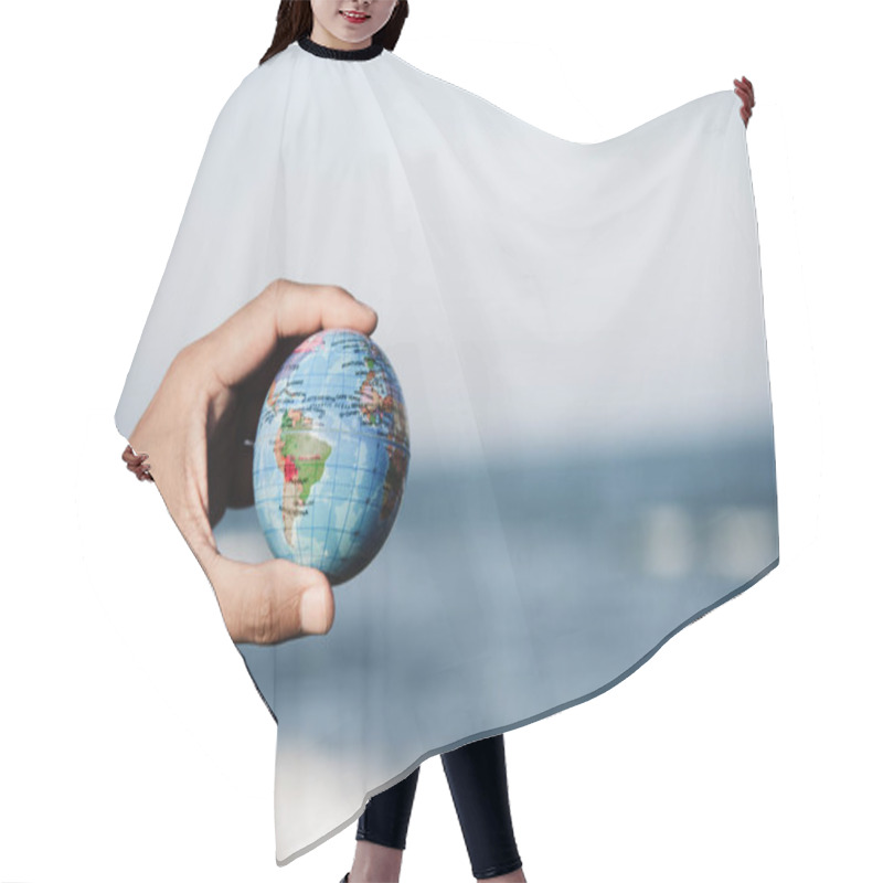 Personality  Young Man With A World Globe In His Hand Hair Cutting Cape