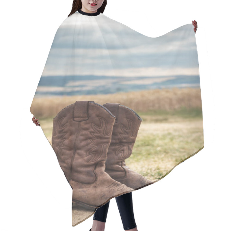 Personality  Cowboy Boot In Rural Scene With Moody Sky. Old Brown Leather Boots Outdoors. Wild West Retro Style Hair Cutting Cape