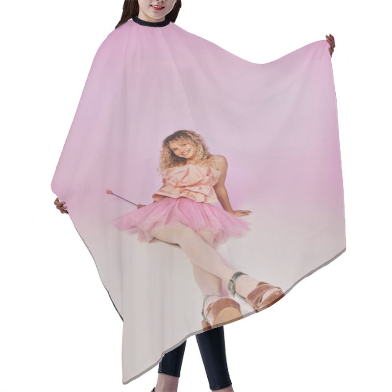 Personality  Lovely Joyous Tooth Fairy In Pink Costume Sitting On Floor With Legs Crossed On Pink Backdrop Hair Cutting Cape