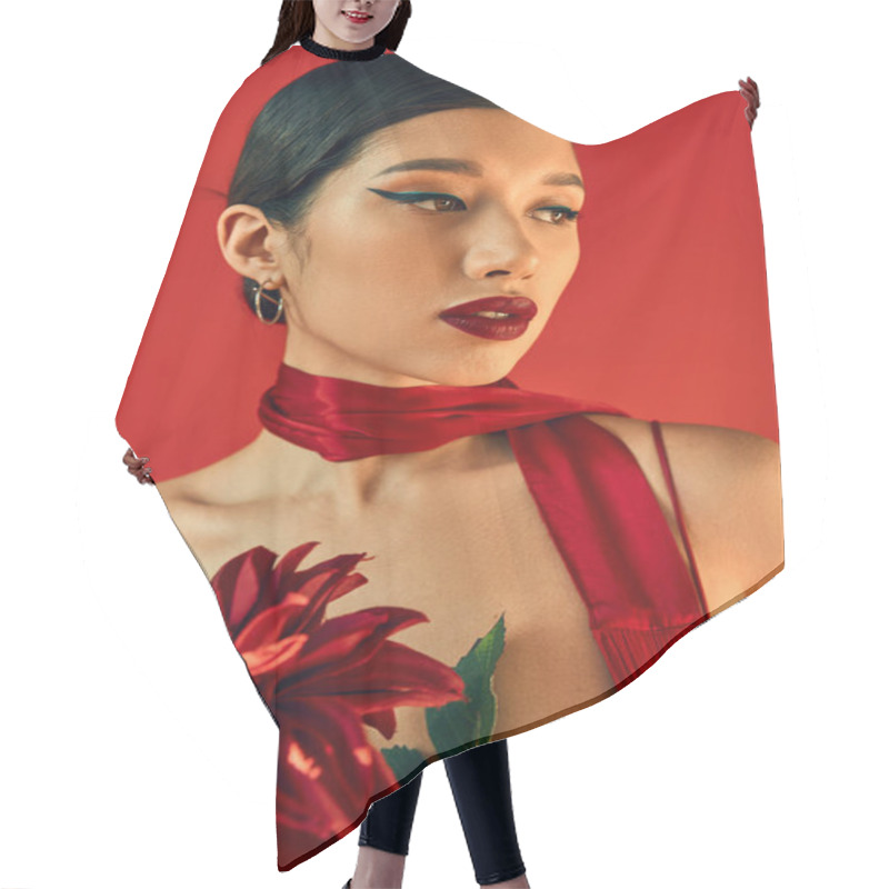 Personality  Portrait Of Young And Mesmerizing Asian Fashion Model With Brunette Hair And Bold Makeup Posing In Trendy Neckerchief And Holding Burgundy Peony On Red Background, Spring Style Concept Hair Cutting Cape