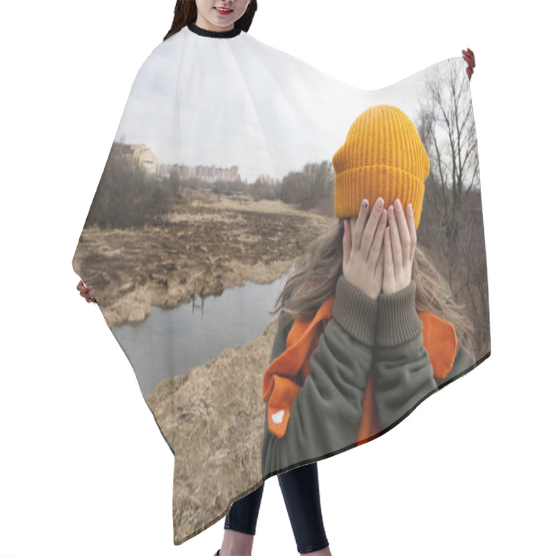 Personality  Sad Teenager In Orange Knitten Hat And Scarf Closed Her Face By Hands, Stand Alone Near The Scorched Field. Spring Time Hair Cutting Cape