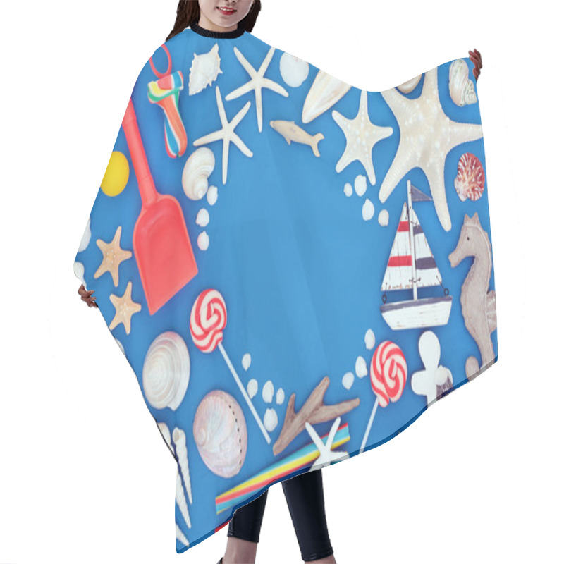 Personality  Summer Holiday Beach And Seaside Items And Symbols With Seashells, Toys, Rock Candy And Suntan Protection Lotion. Summer Holiday Themed Concept On Blue Background With Copy Space.  Hair Cutting Cape