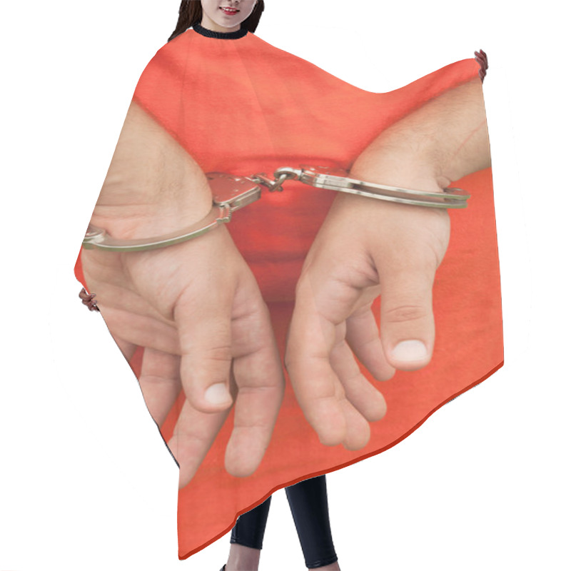 Personality  Close-up Image Of Hands In Handcuffs Behind A Person's Back Against An Orange Shirt Or Jumpsuit Hair Cutting Cape