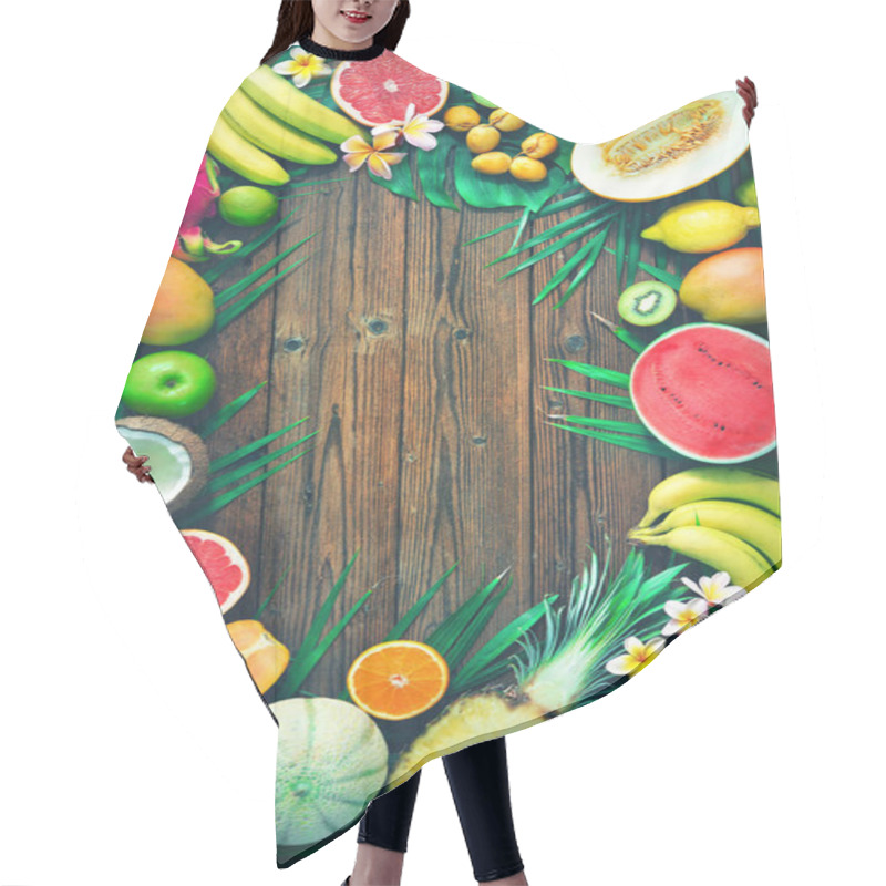 Personality  Assortment Of Tropical Fruits With Leaves Of Palm Trees And Exotic Flower On Dark Wooden Background. Top View Hair Cutting Cape