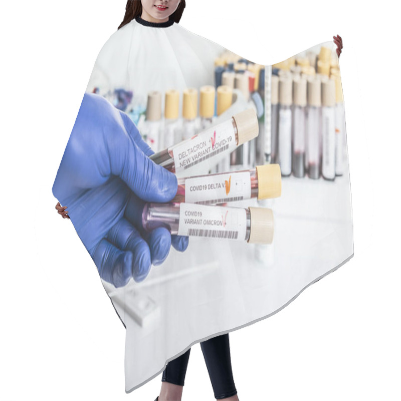 Personality  Researcher With Blood Sample Of New Variant Of The Covid-19 DELTACRON And Generic Data Of Covid-19 Coronavirus Mutations. Doctor In Analysis Lab Holding Sample Of New Strain Of Covid DELTACRON. Hair Cutting Cape