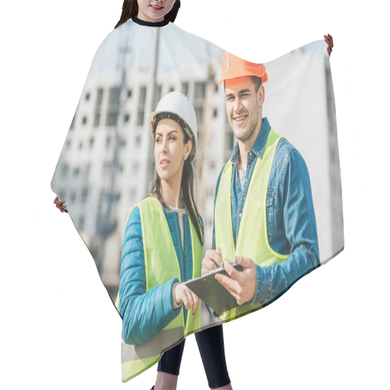 Personality  Female Surveyor Talking To Smiling Colleague With Clipboard Hair Cutting Cape