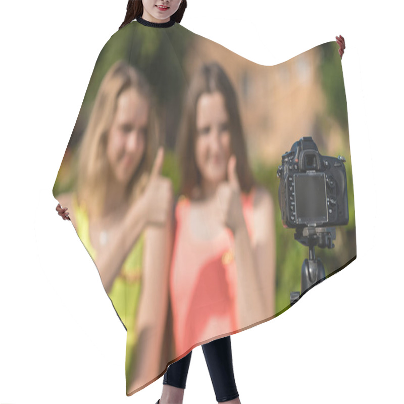 Personality  Two Teenage Girls, In Summer In The Park, Are Recording Video On The Camera. Blurred Background Free Space For Text. Hair Cutting Cape